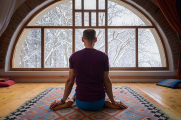 Yoga meditation in front of the window