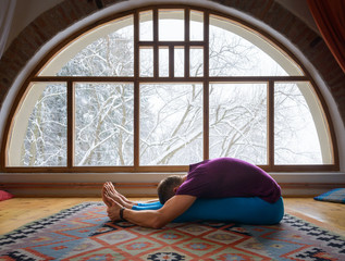 male doing stretching exercises at home