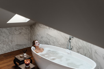 Sensual woman lying in hot foam bath