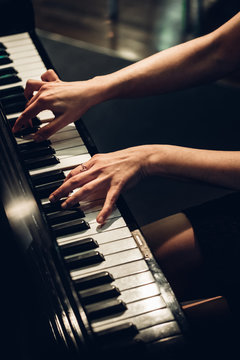 anonymous woman playing piano