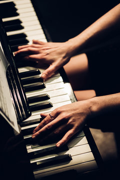 anonymous woman playing piano
