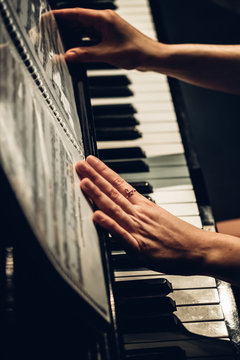 anonymous woman playing piano