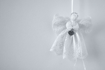 Christmas decoration. White angel on grey background. Space for text or logos