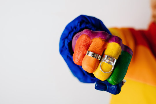 Closeup of colored hand in silver rings