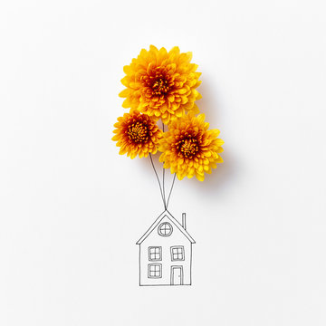 Creative Drawing Of A House With Natural Orange Flowers On A Gra