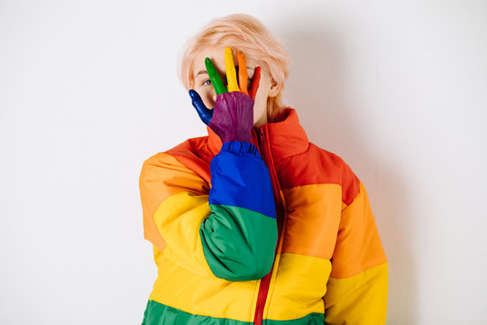 Woman with colored hand posing in bright coat