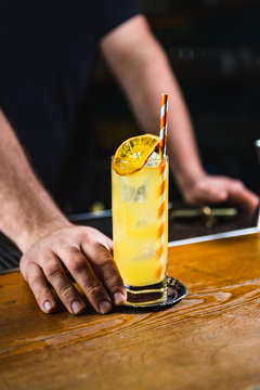 Unrecognizable Bartender Serving an Alcoholic Drink on the Count