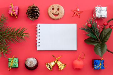 Creative Composition Useful for Christmas and New Year Greeting Card Created Using Gift Boxes, Christmas Bell, Pine Branch, Pine Cone, Chestnut, Cookie Smiley, Red Star and Blank Paper For Copy