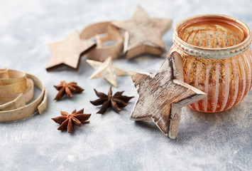 Christmas decoration (wooden Stars and spices) on bright background. Close up. 