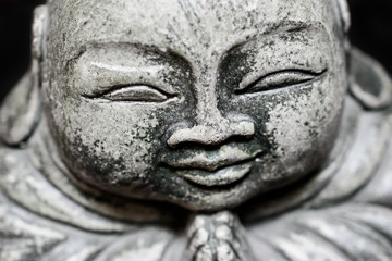 Fototapeta na wymiar Closeup of a stone sculpture Buddah's face