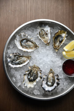Overhead view of oysters in ice bowl on table