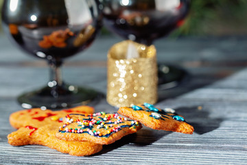 Christmas ginger cookies near the New Year tree on a wooden table.