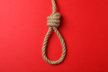 Suicide rope on red background, space for text