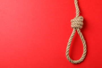 Suicide rope on red background, space for text