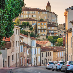 Fototapeta na wymiar Summer city landscape - view of a street and medieval houses in the town of Auch, in the historical province Gascony, the region of Occitanie of southwestern France