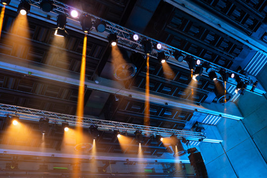 Stage Lights. Orange And Blue Spot Lights On Steel Construction. Lightning Equipment.