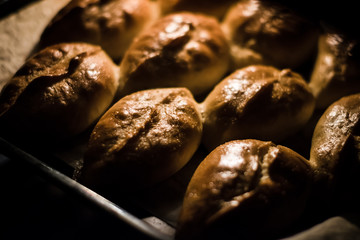 Baked pies on a tray in the oven