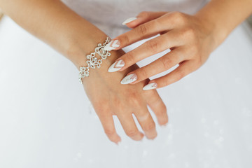 The bride straightens a beautiful bracelet on her hand