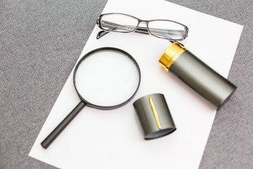 Fototapeta premium Magnifier,glasses and notebook