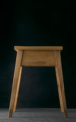 Handmade stool oak wood on a black background