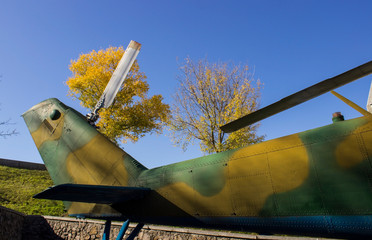 military guns and propellers from helicopters and autumn trees