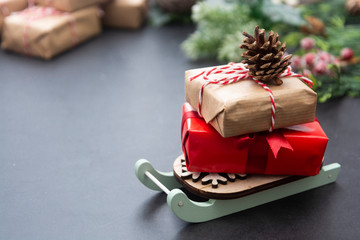 Christmas background or greeting cards, mock up with gift boxes on sleigh over gray background. Winter holidays. Copy space.