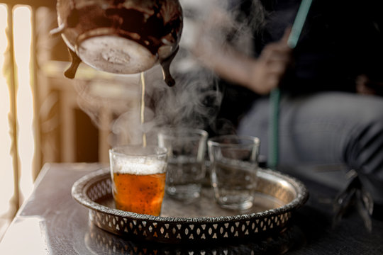 Pouring Moroccan Traditional Tea In A Glass