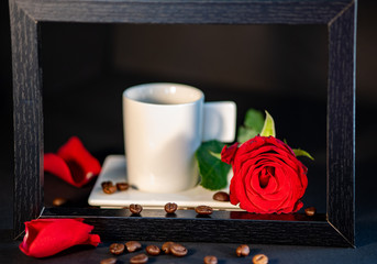 red cup of coffee and flowers on the table