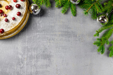 Christmas cake with pine branches on grey table. Happy new year concept. Christmas background