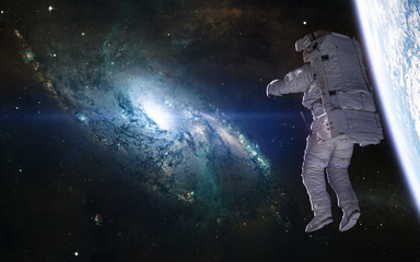 Fototapeta na wymiar Messier 106 galaxy, planet, astronaut. Beautiful cosmic landscape. Science fiction. Elements of this image furnished by NASA