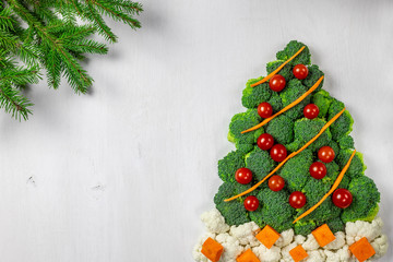 Edible Christmas tree shaped vegetable isolated on white background for holiday seasonal festive party celebration with healthy food decoration. Cooking step by step