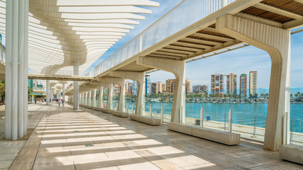 Beautiful gallery in Malaga harbour on a sunny summer day, Spain.