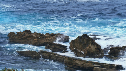 Coast of the sea with waves crashing on the rocks