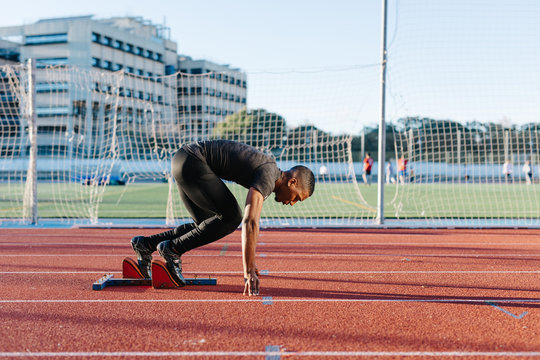 Black sportsman preparing to run race