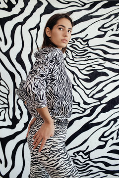 Slim model near zebra wall
