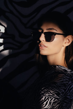 Elegant lady in clothes with zebra print and sunglasses