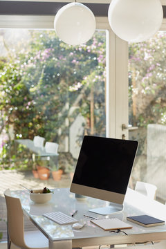 Desk table with computer and big window