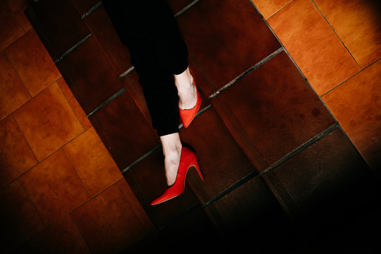 Low section of man in red heels