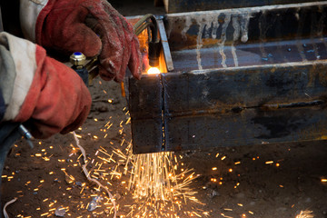 Cutting a steel beam with a gas torch. Industrial metal cutting.