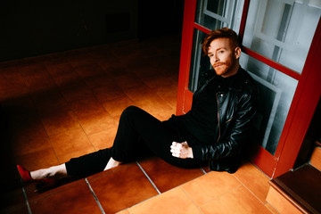 Redhead cool man posing with heels