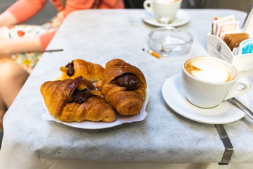 Italian breakfast with filled croissants and cafe