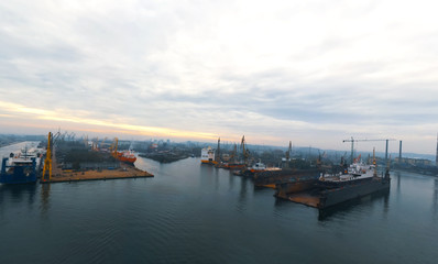 Sunrise panorama Remontova shipyard with ships in to dry docks. Gdansk, Poland, drone footage, natural light.