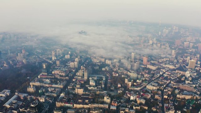 Aerial view above to very dense morning fog over city. Smog or fog in the city. Problem of pollution of the environment 4k