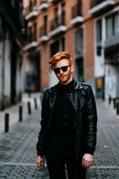 Redhead cool man walking down the street on red high heels