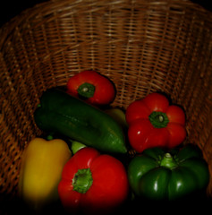 Red, yellow and green peppers in a basket
