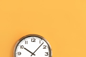 Part of big wall clock on orange background