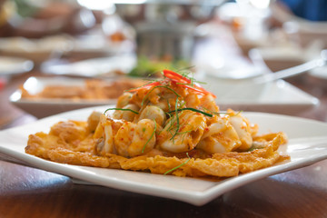 Seafood omelet in white plate.