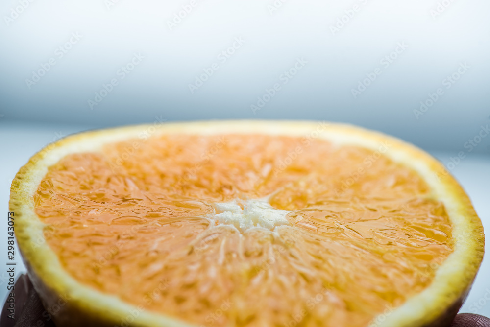 Poster Sliced orange in half on a white background