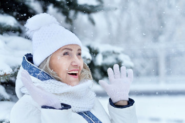 Happy beautiful senior woman in warm hat