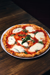 Pizza with mozzarella and black background